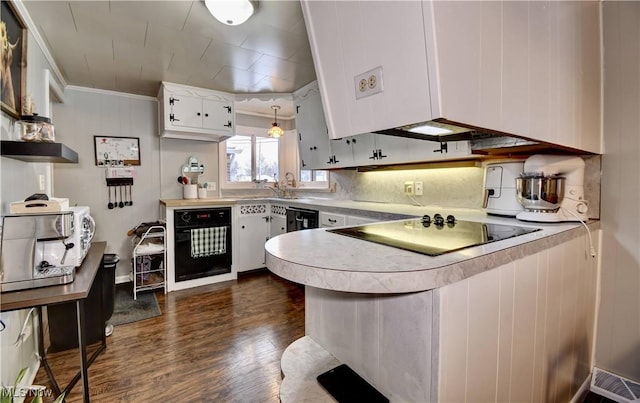 kitchen featuring white cabinets, black appliances, dark hardwood / wood-style floors, and kitchen peninsula