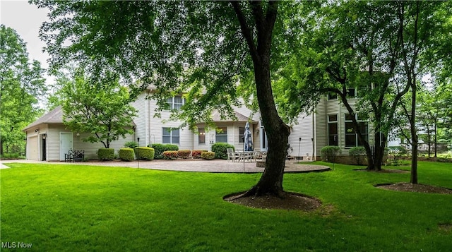 view of front of home with a garage and a front lawn