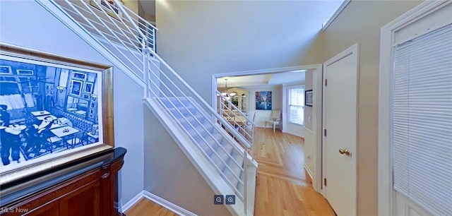 staircase featuring parquet floors and a chandelier