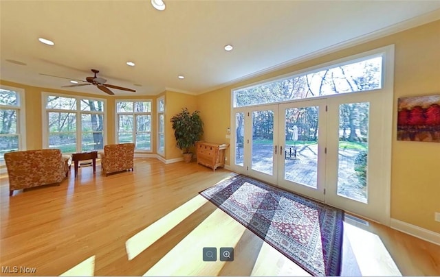 doorway featuring ornamental molding, light hardwood / wood-style floors, and french doors