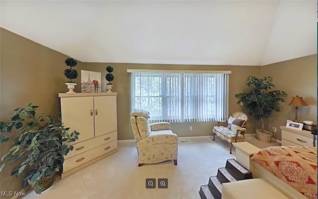 living area featuring vaulted ceiling and light colored carpet