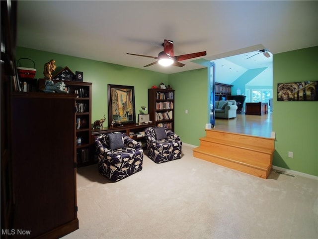 sitting room featuring ceiling fan, vaulted ceiling, and carpet floors