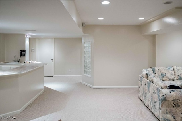 interior space featuring sink and light colored carpet