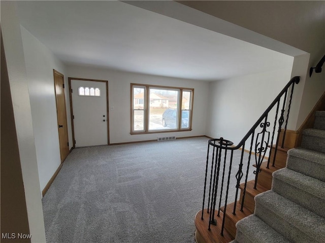 foyer featuring carpet flooring