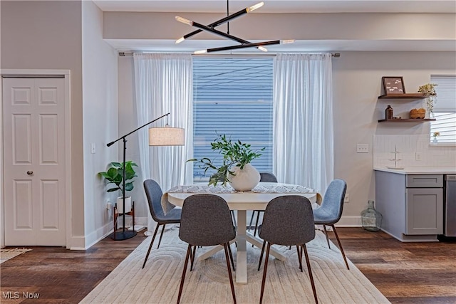 dining room featuring an inviting chandelier and dark hardwood / wood-style flooring