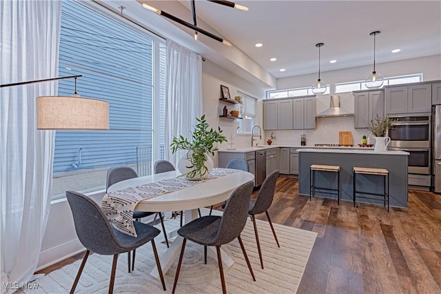 dining area with dark hardwood / wood-style flooring and sink