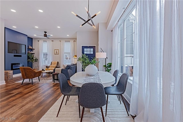 dining space featuring hardwood / wood-style flooring and a chandelier