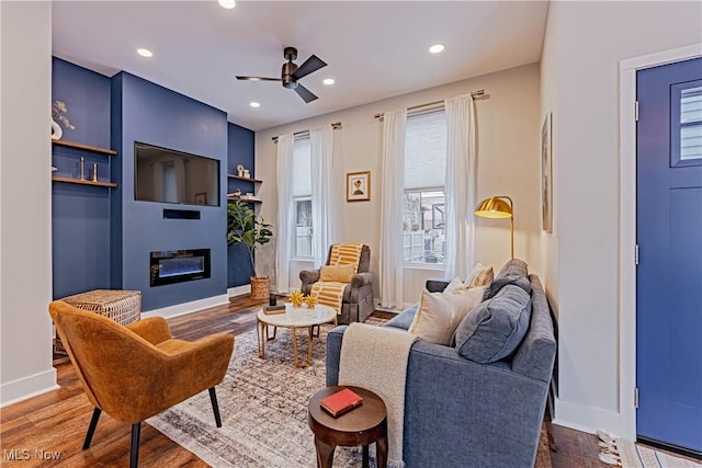 sitting room featuring ceiling fan and wood-type flooring