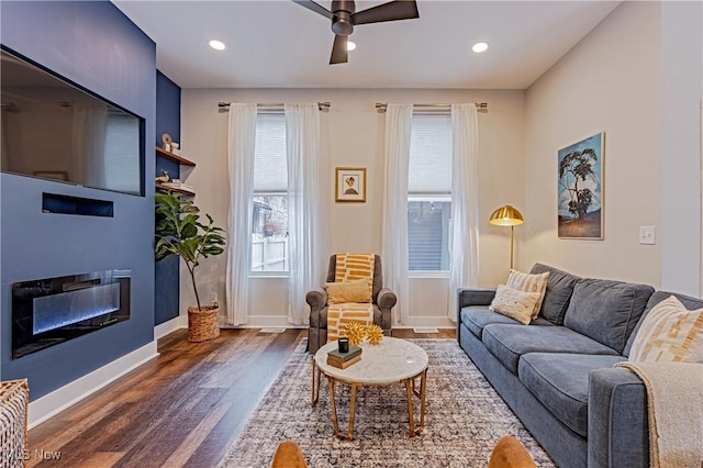 living room with dark hardwood / wood-style floors and ceiling fan