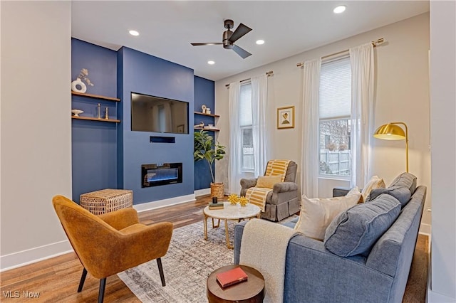 sitting room featuring hardwood / wood-style flooring and ceiling fan