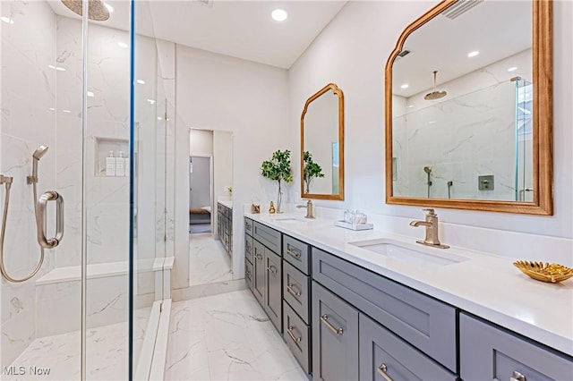 bathroom with vanity and a shower with door