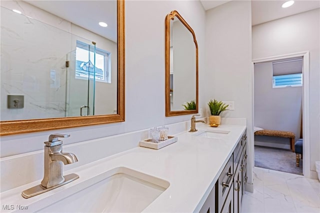 bathroom with vanity and a shower with door