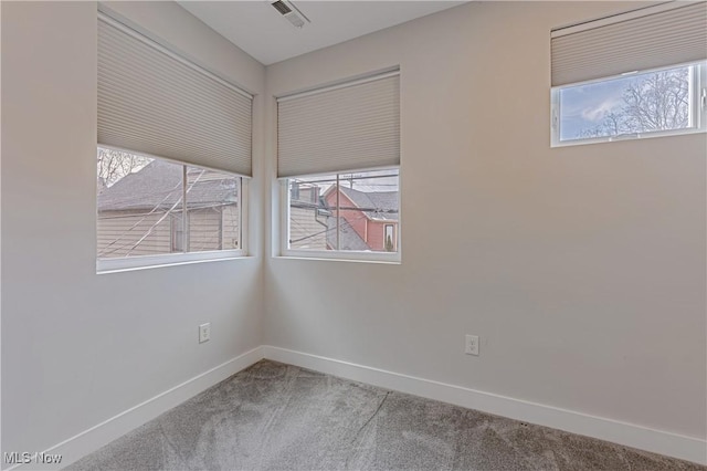 unfurnished room with a wealth of natural light and carpet flooring