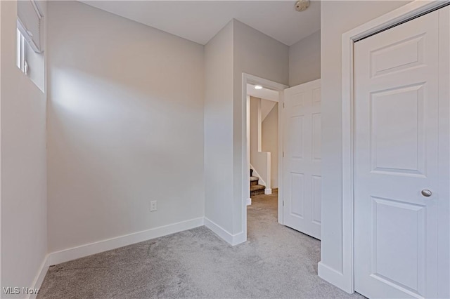 unfurnished bedroom with light colored carpet