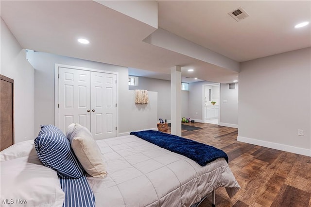 bedroom featuring hardwood / wood-style floors and a closet