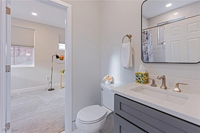 bathroom with vanity, toilet, and walk in shower