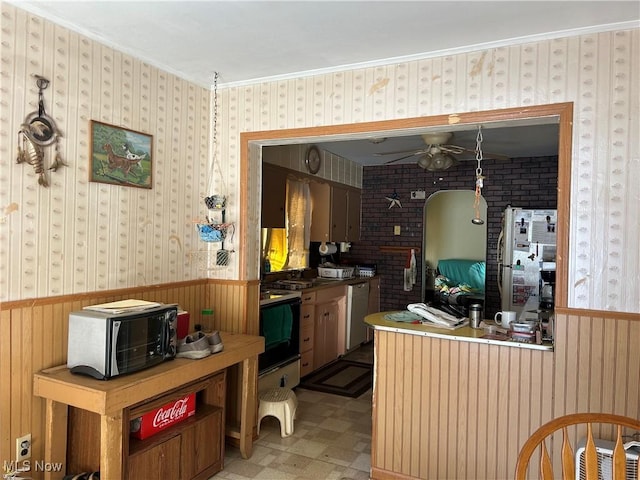 kitchen with stove, crown molding, stainless steel dishwasher, and ceiling fan