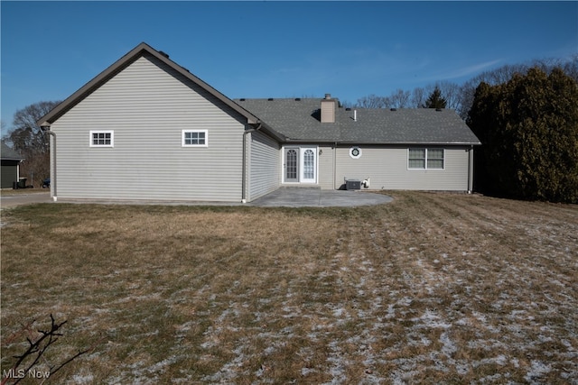 rear view of house featuring a patio area and a yard