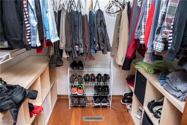spacious closet with hardwood / wood-style floors