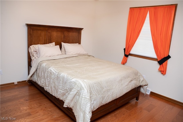 bedroom with wood-type flooring