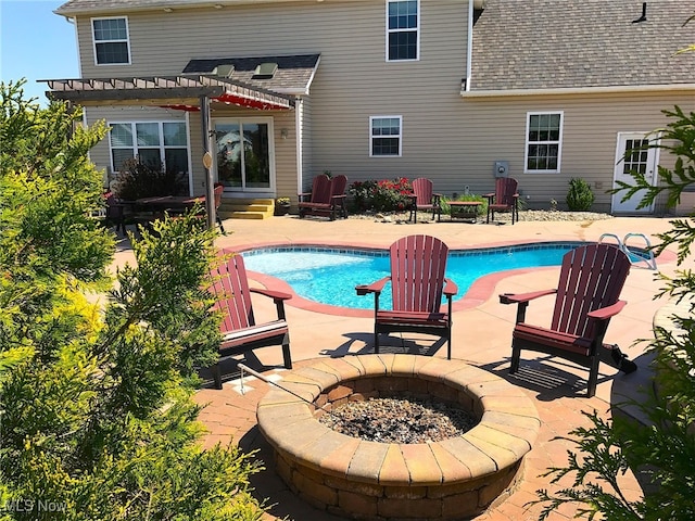 view of swimming pool with a patio area, a pergola, and a fire pit