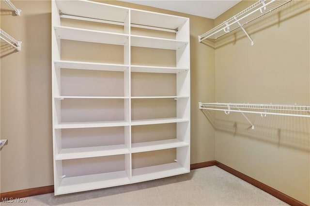 walk in closet with carpet