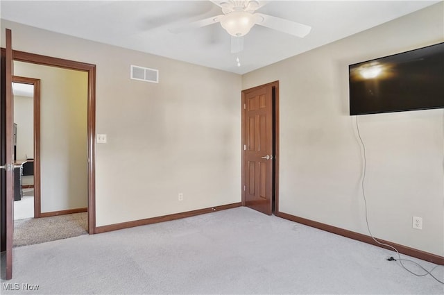 spare room with light carpet and ceiling fan