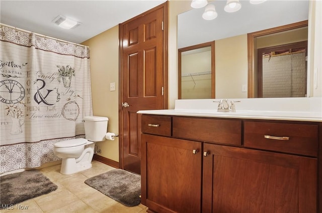 bathroom featuring curtained shower, vanity, tile patterned flooring, and toilet