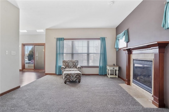 unfurnished room with carpet and a tiled fireplace