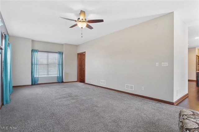 carpeted spare room featuring ceiling fan