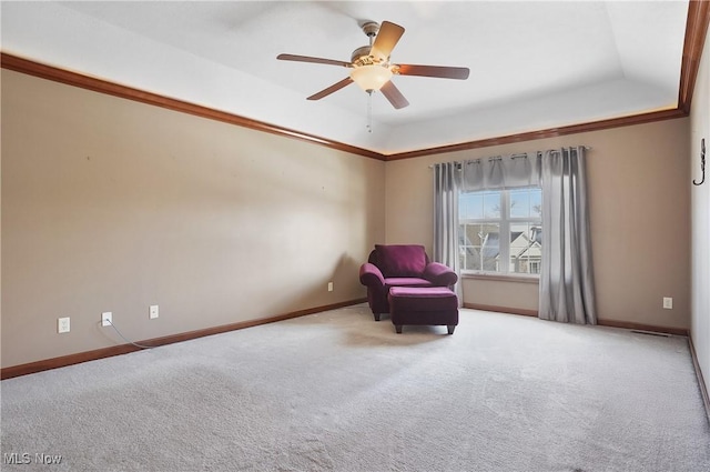 unfurnished room featuring a tray ceiling, carpet, and ceiling fan