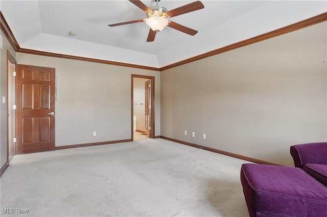 unfurnished room featuring light carpet, ceiling fan, a raised ceiling, and ornamental molding