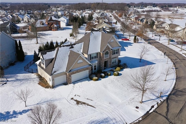 snowy aerial view with a residential view