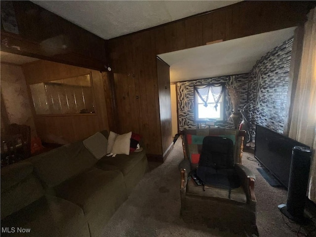 living room featuring a wood stove, carpet floors, and wooden walls