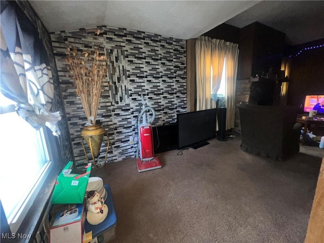 interior space featuring lofted ceiling and carpet flooring