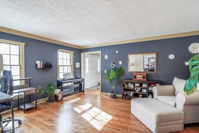 living room with light hardwood / wood-style floors, crown molding, and a textured ceiling