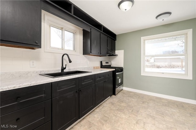 kitchen with a healthy amount of sunlight, sink, and stainless steel gas stove