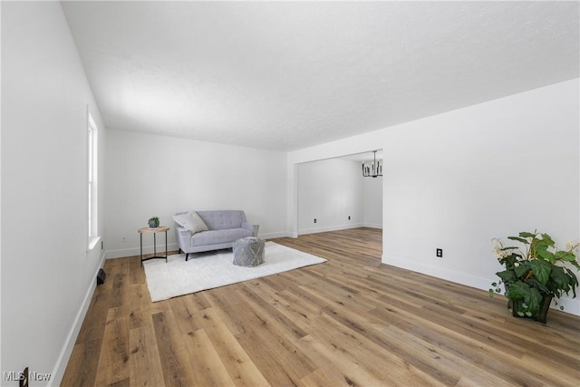 sitting room featuring light wood-type flooring and a textured ceiling