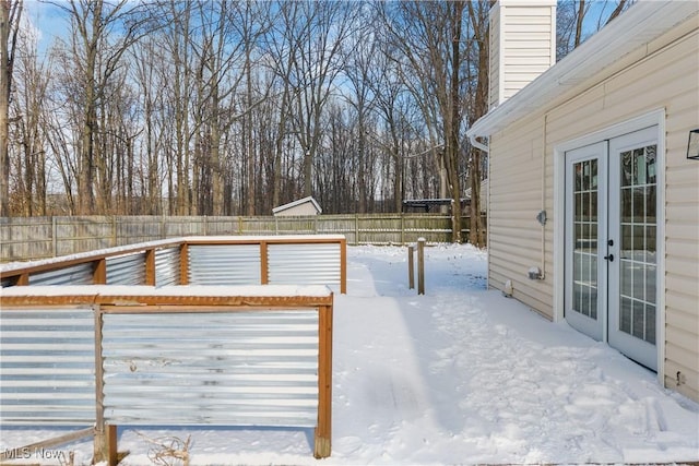 snow covered patio with french doors