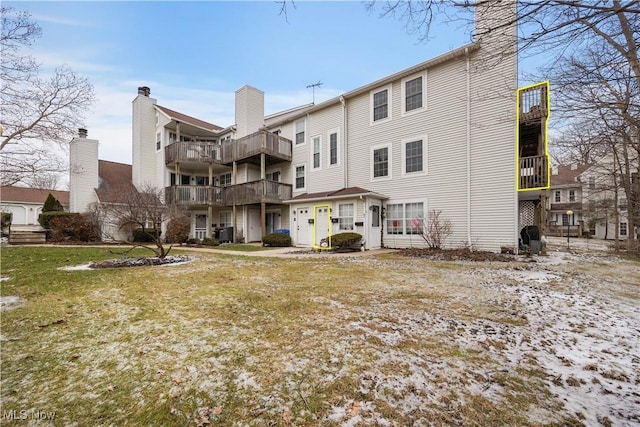 rear view of property with a yard and central air condition unit