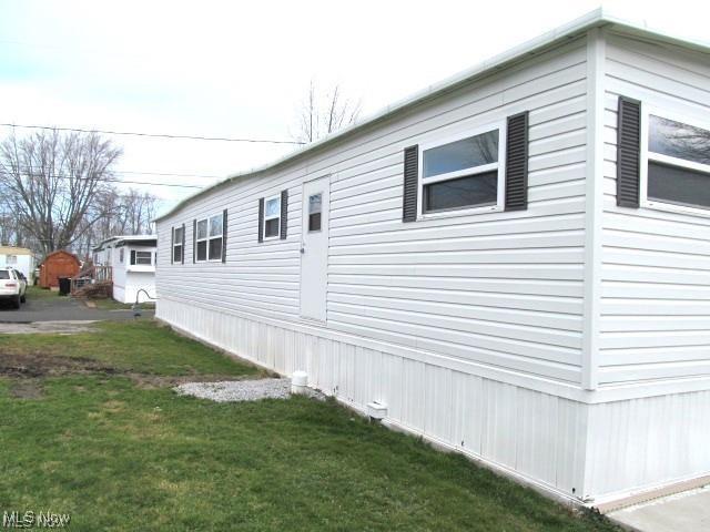 view of side of home featuring a lawn