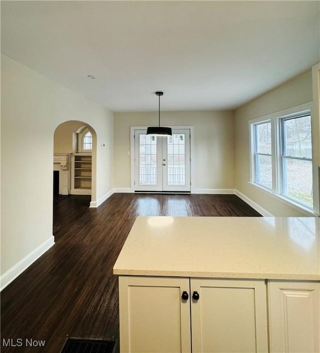 unfurnished dining area featuring dark hardwood / wood-style floors and french doors