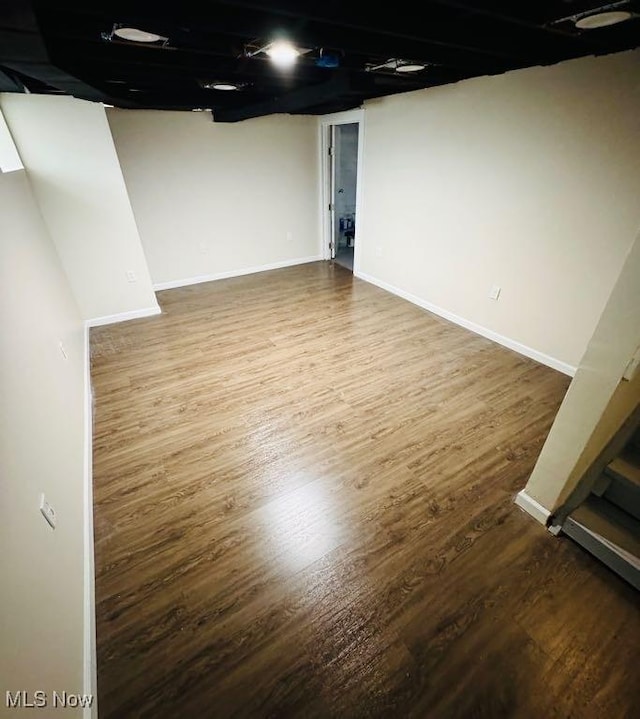 basement with hardwood / wood-style floors