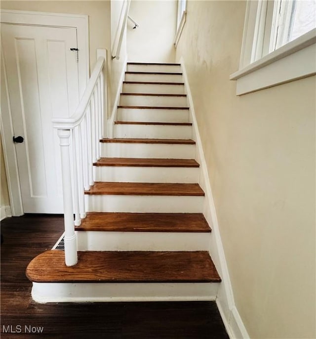 staircase featuring wood-type flooring