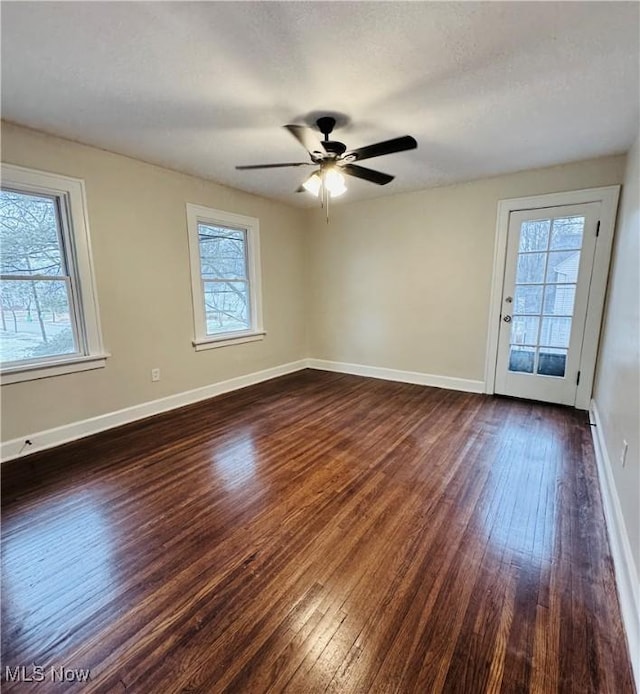 spare room with ceiling fan, dark hardwood / wood-style floors, and a textured ceiling