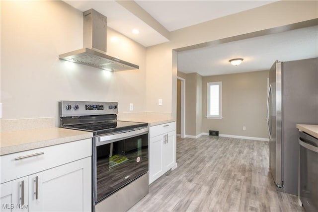 kitchen with white cabinets, island exhaust hood, stainless steel appliances, and light hardwood / wood-style flooring