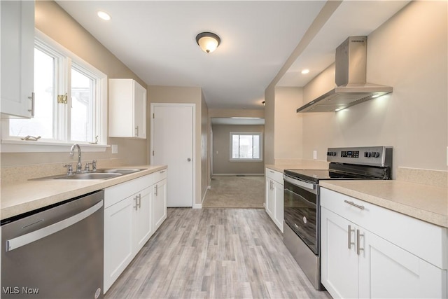 kitchen with white cabinetry, stainless steel appliances, sink, and island range hood