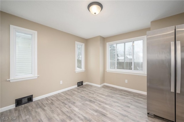 unfurnished room with light wood-type flooring