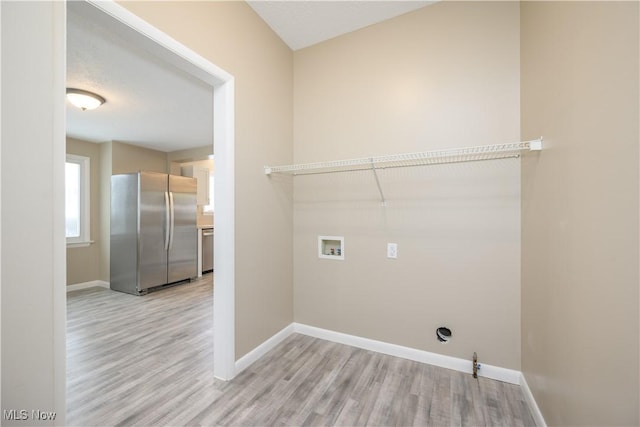 laundry room featuring hookup for a gas dryer, light hardwood / wood-style flooring, and hookup for a washing machine