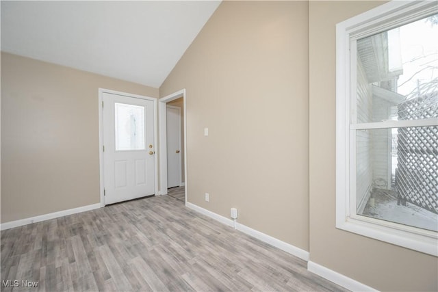 foyer featuring light hardwood / wood-style floors and vaulted ceiling